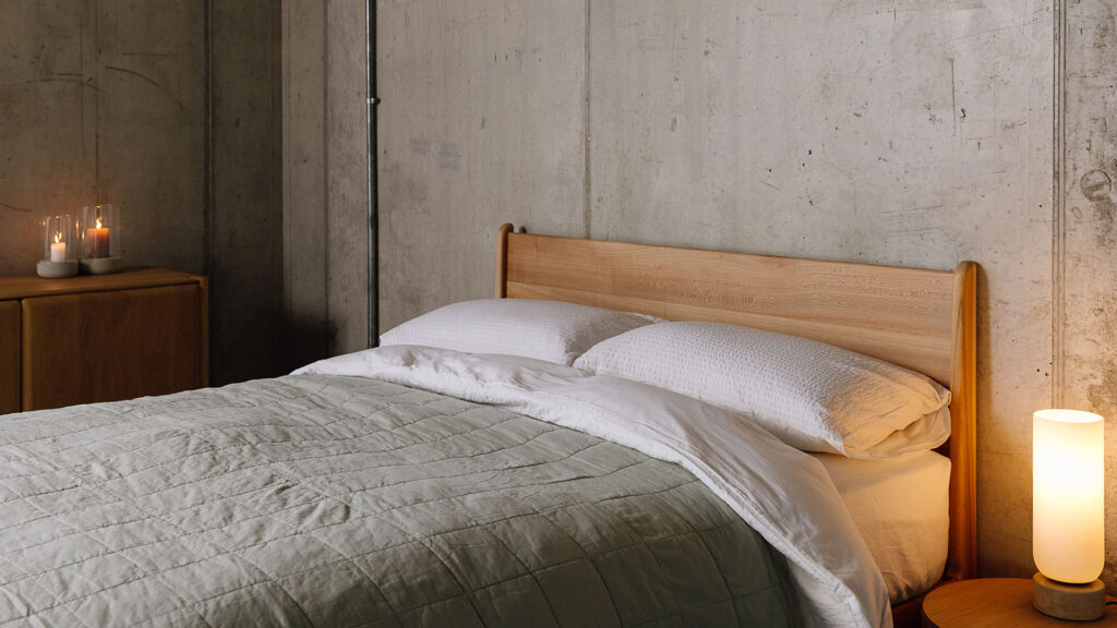 Scottish Elm Camden bed with white seersucker bedding and muted sage quilted bedspread.