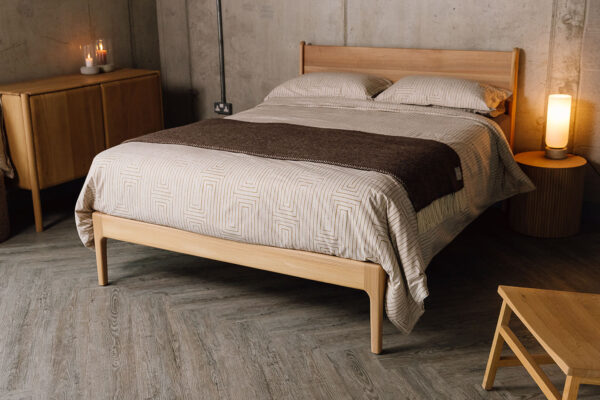 Scottish Elm Camden bed with gold grid pattern cotton duvet set. Room set with oak furniture.