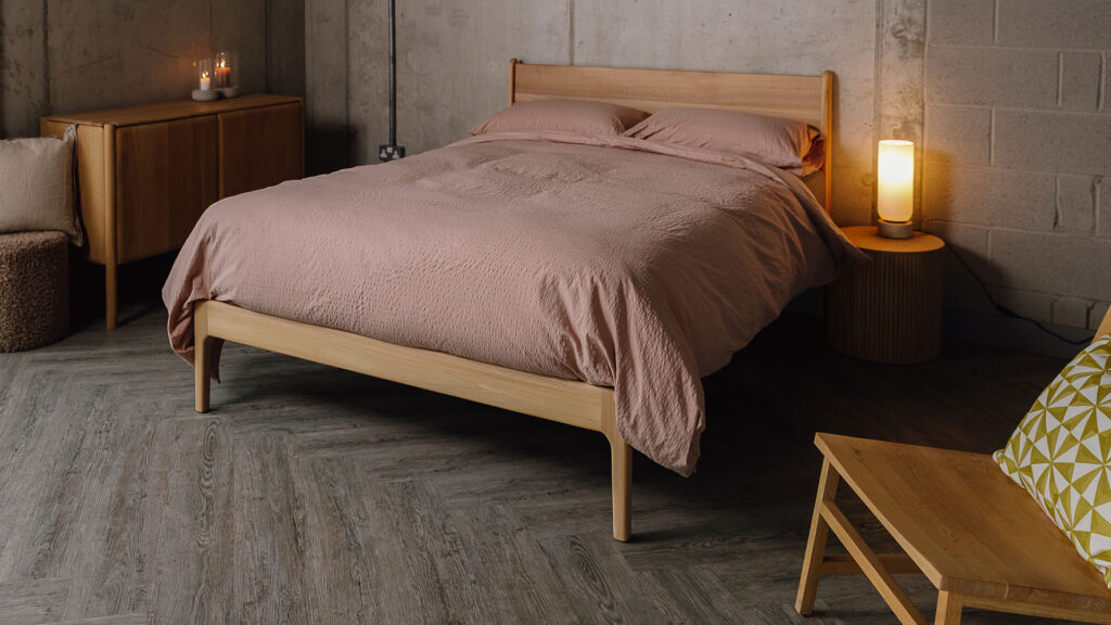 Dusty pink bedding with seersucker texture on Scottish Elm Camden bed.