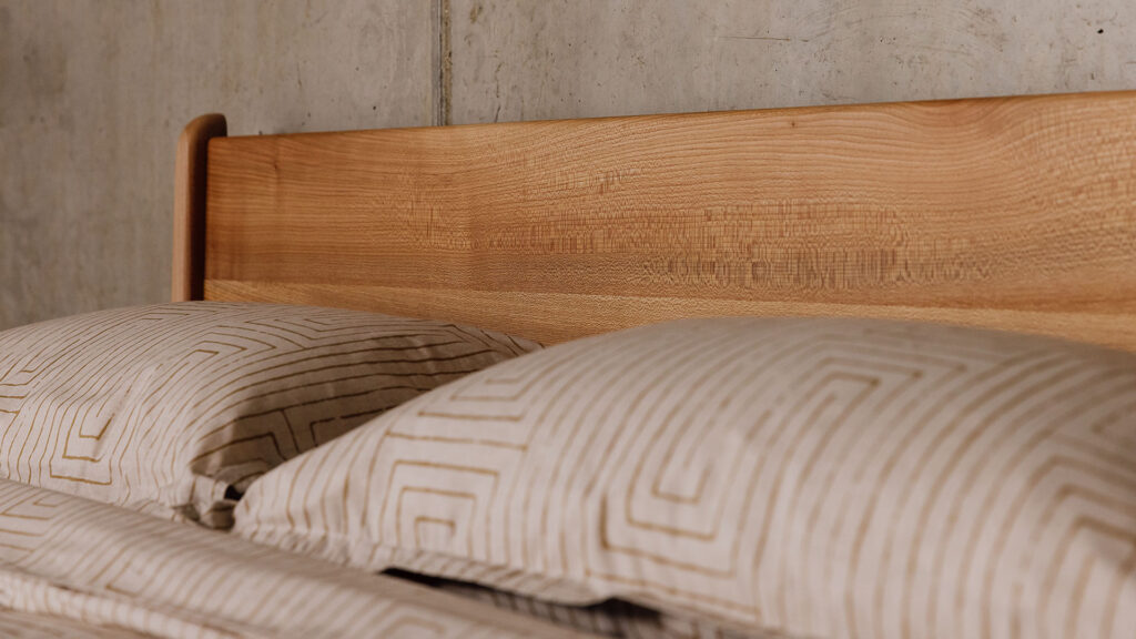 Scottish Elm Camden headboard detail with gold grid pattern bedding set.