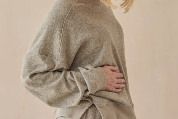 Soft grey sweatshirt with side split.