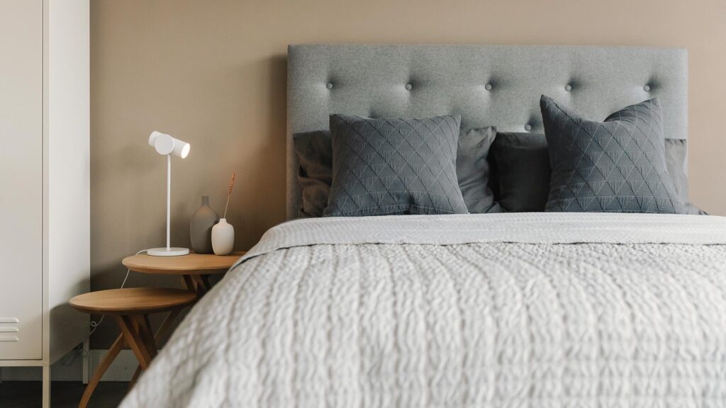 skye bed with grey bedding and twist tables