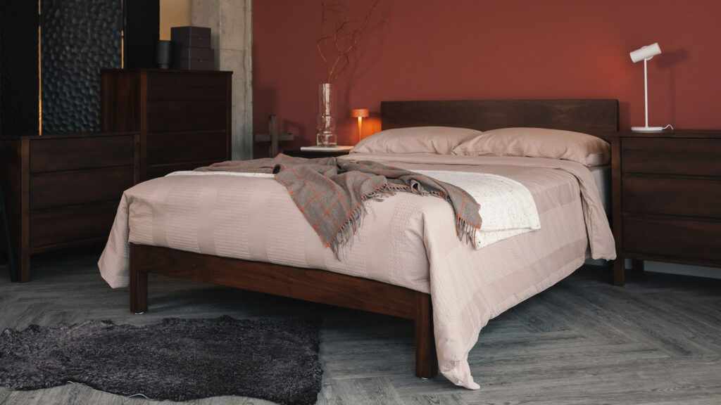 smoked walnut finish Malabar bed with plaster colour bedding and cashemere throw