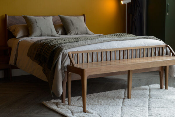 spindle becnh in recalimed teak in front of walnut Hoxton bed