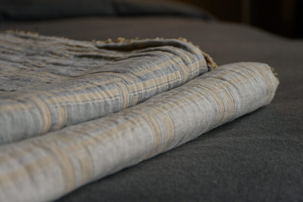 stack of check throws in grey and gold