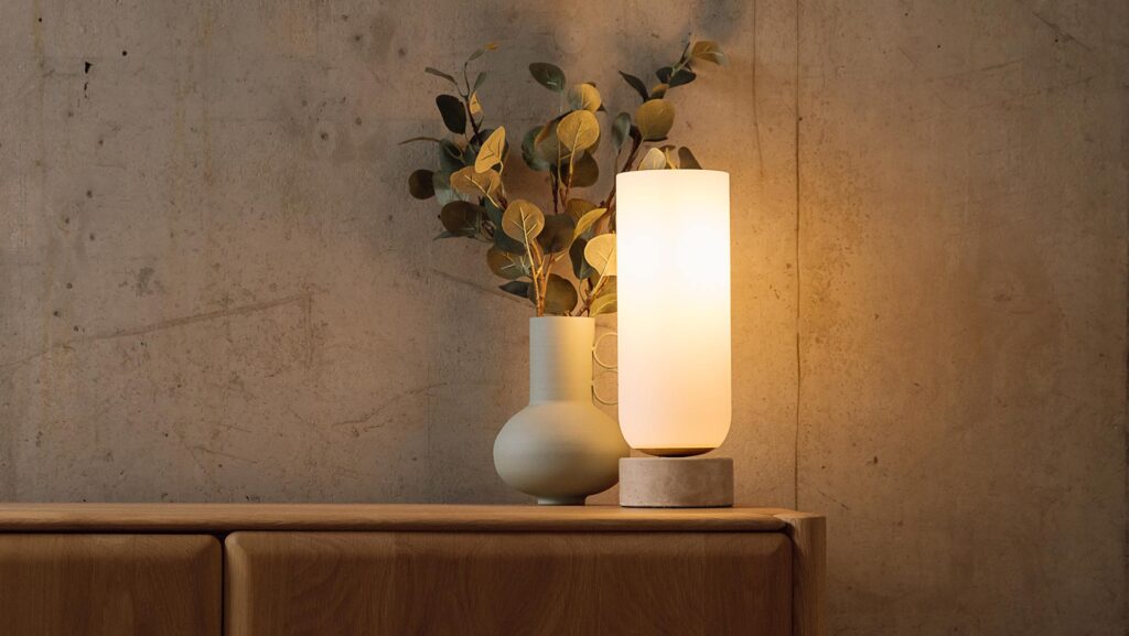 Lamp with stone base and soft glow column light.