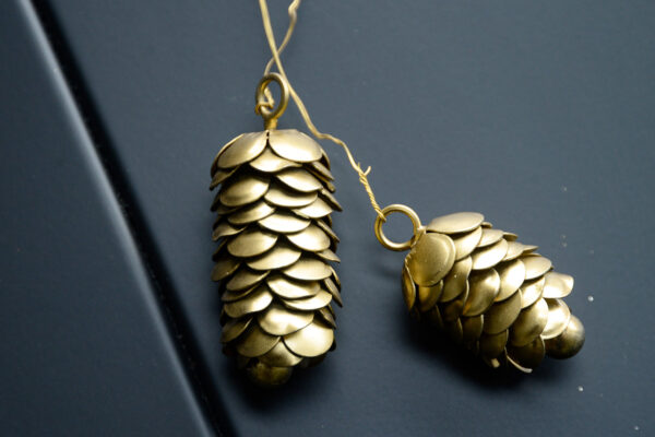 two gold colour pine cone decorations