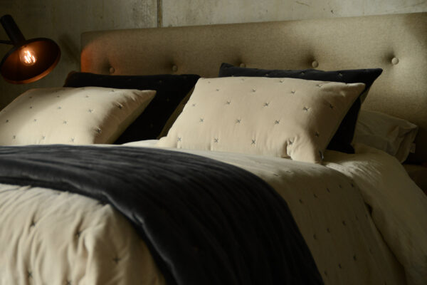 velvet quilts and cushions with cross pattern stitch detail