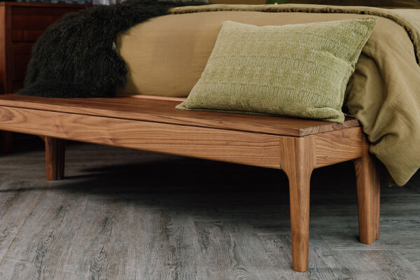 Walnut Camden bench with green cushion on top.