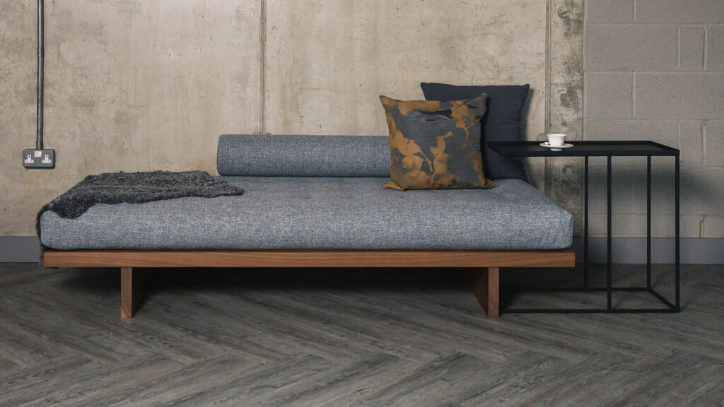 walnut daybed with grey mattress and bolster