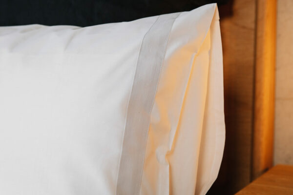 white cotton bedding with pale grey linen border pillowcase