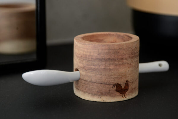 wooden egg cup and porcelain spoon