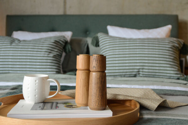 wooden salt and pepper grinder with mug on tray